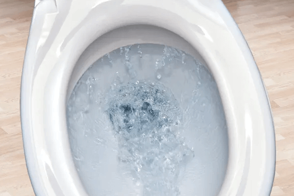 Water Trickling into Toilet Bowl